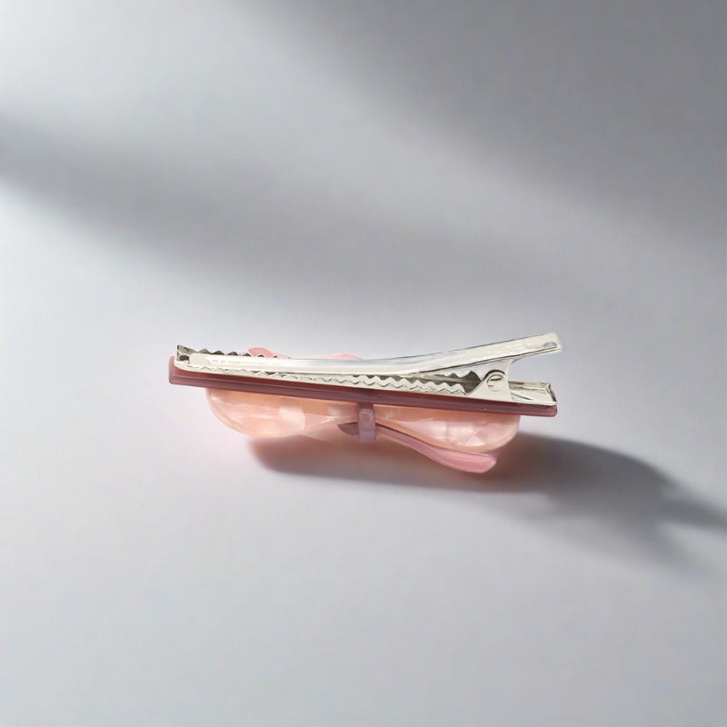 Bow shaped hair clip for women and girls available in a range of pretty and subtle, stylish colours. Each clasp secures easily to all hair types - short and long, fine and thick. These clips can also be used on clothing, shoes and bags to add a point of distinction and a fashionable emphasis. Made from quality acrylic acetate which is an eco-friendly recyclable plastic material.
